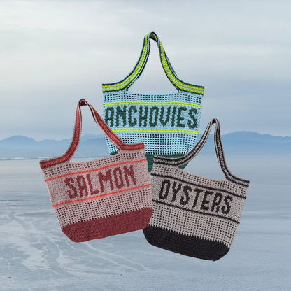 Three crocheted bags with text on an Italian ocean cliffside background